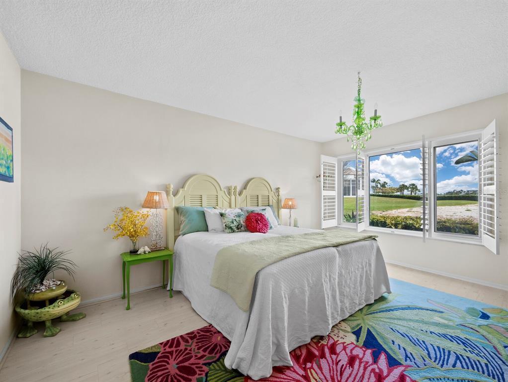 100 Sands Point Road, Unit 108 Longboat Key, FL 34228 - Photo 22 of 46 a bedroom with a bed and a window