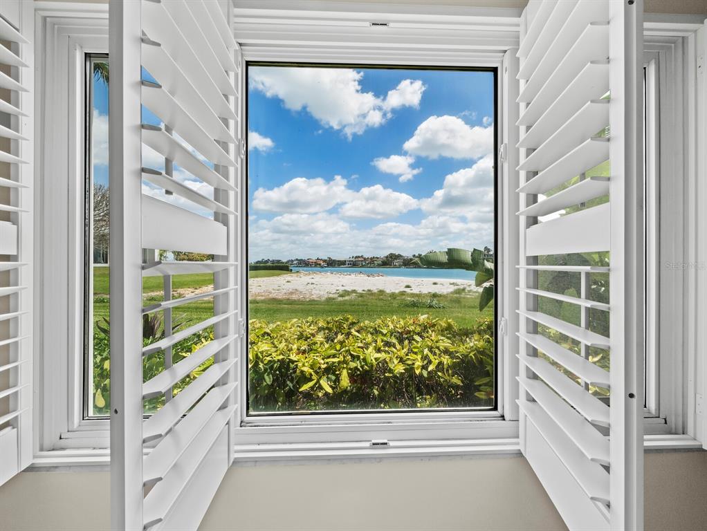 100 Sands Point Road, Unit 108 Longboat Key, FL 34228 - Photo 23 of 46 a view of a glass door with a view of the house