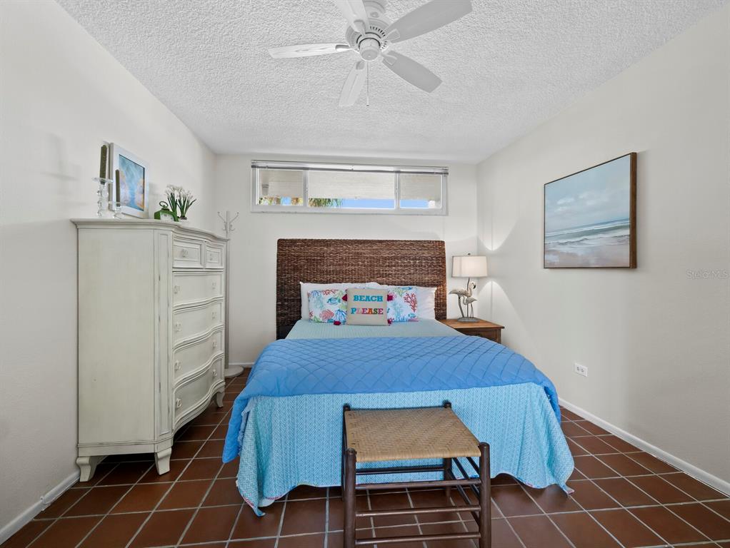 100 Sands Point Road, Unit 108 Longboat Key, FL 34228 - Photo 25 of 46 a bedroom with a bed and a view of kitchen