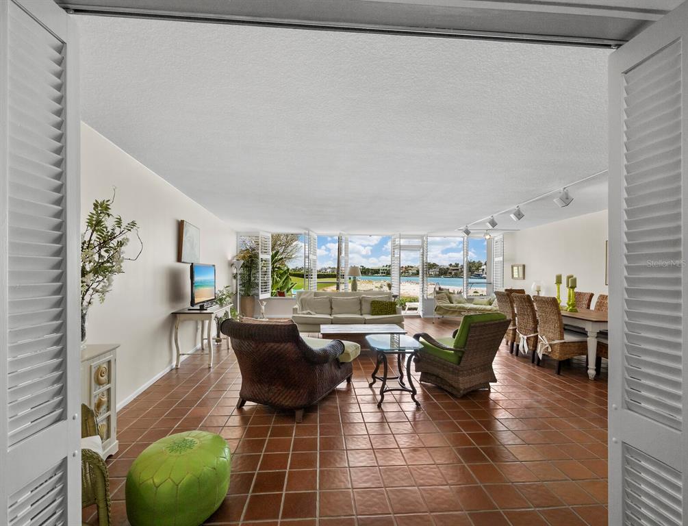 100 Sands Point Road, Unit 108 Longboat Key, FL 34228 - Photo 26 of 46 a living room with lots of furniture and a potted plant