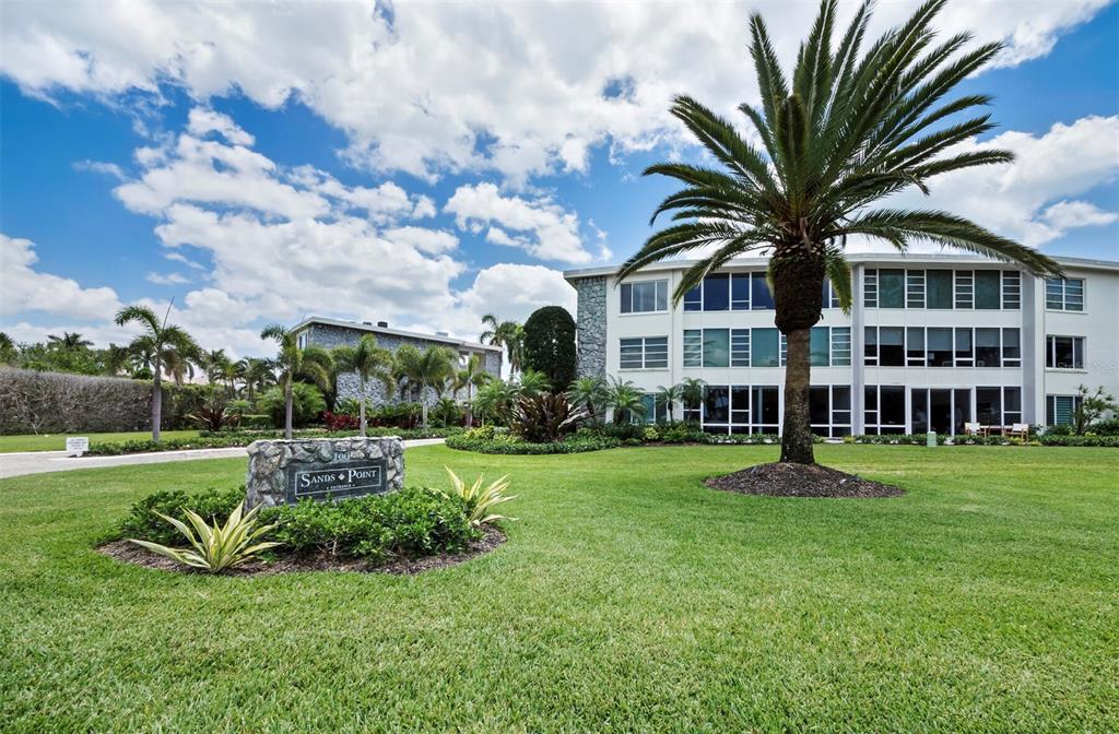 100 Sands Point Road, Unit 108 Longboat Key, FL 34228 - Photo 29 of 46 a front view of a house with a yard table and chairs
