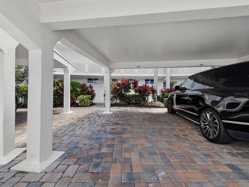 100 Sands Point Road, Unit 108 Longboat Key, FL 34228 - Photo 34 of 46 a living room with furniture gym equipment and potted plants