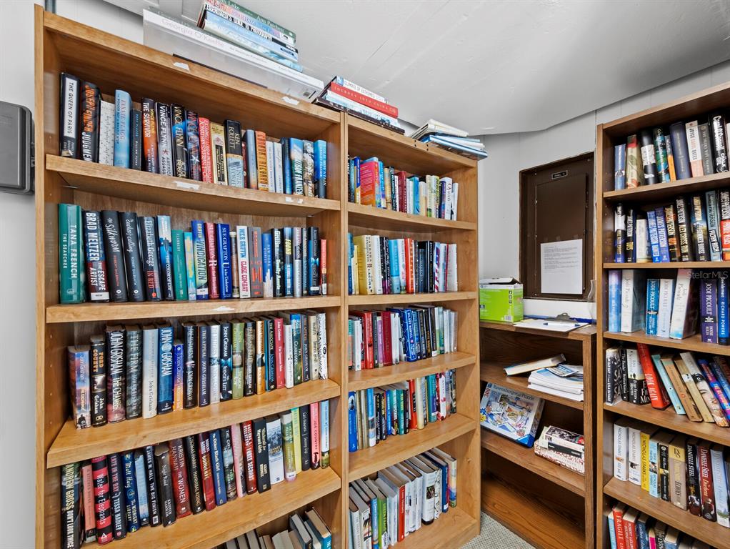 100 Sands Point Road, Unit 108 Longboat Key, FL 34228 - Photo 40 of 46 a book room with large book shelf and book shelf