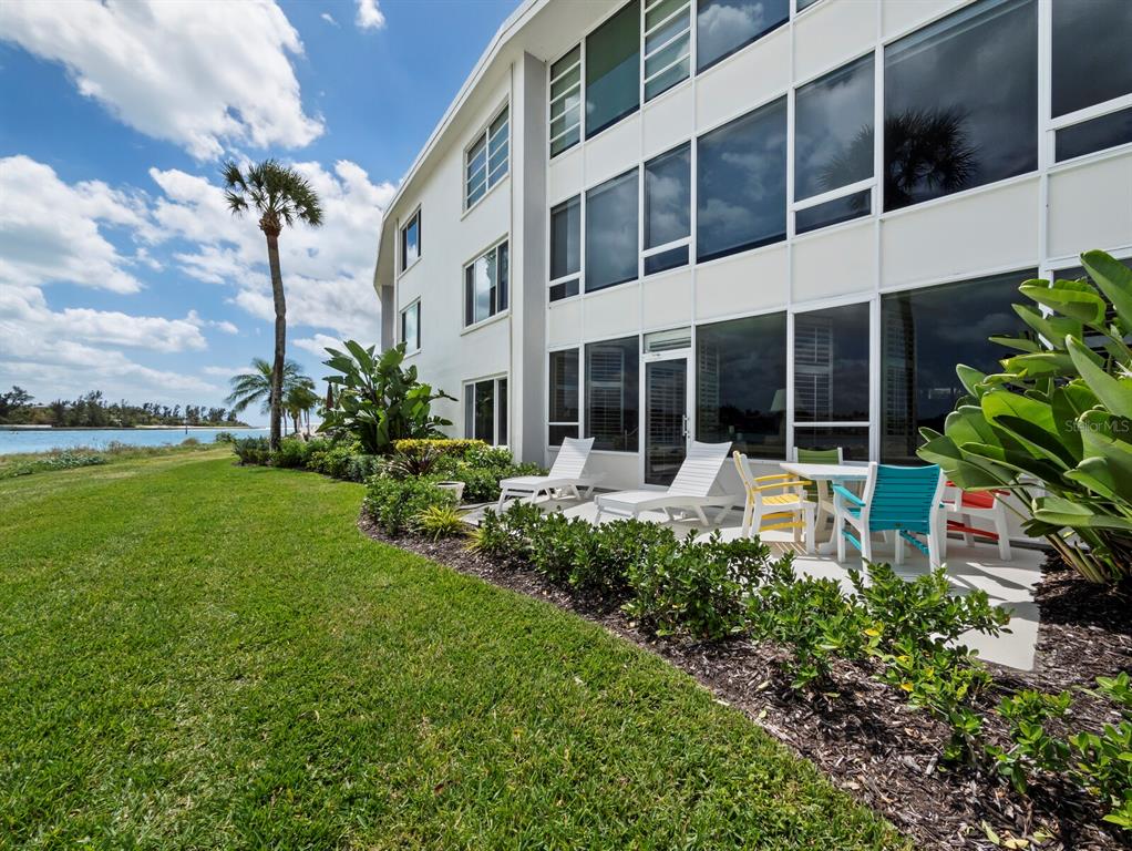 100 Sands Point Road, Unit 108 Longboat Key, FL 34228 - Photo 8 of 46 a view of building with garden