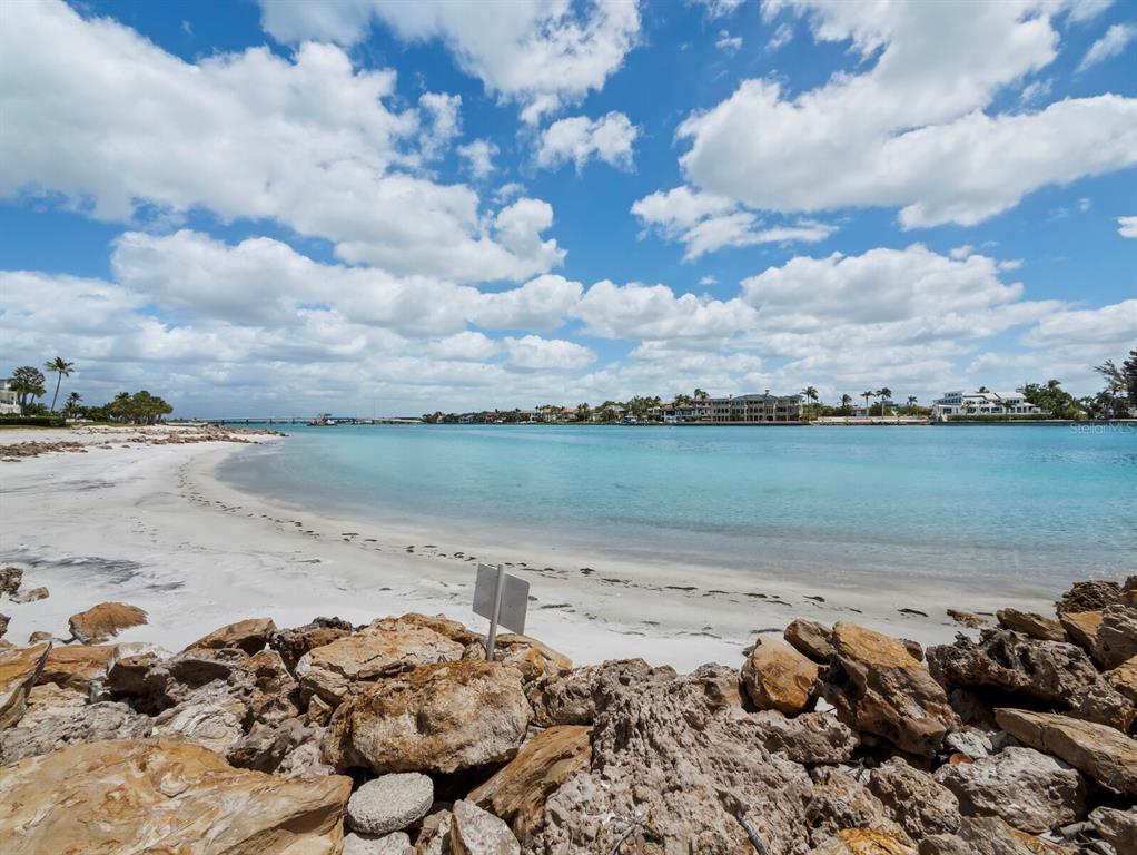 100 Sands Point Road, Unit 108 Longboat Key, FL 34228 - Photo 9 of 46 a view of a lake with a beach