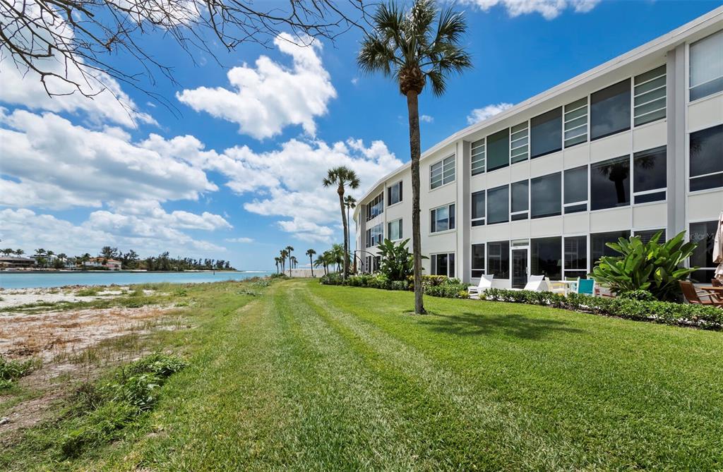 100 Sands Point Road, Unit 108 Longboat Key, FL 34228 - Photo 10 of 46 a view of a building with a yard