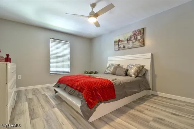 a bedroom with a large bed and a window