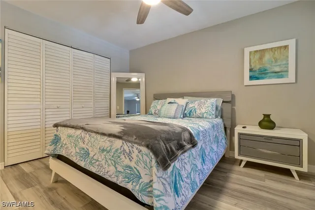 a bedroom with a bed and ceiling fan