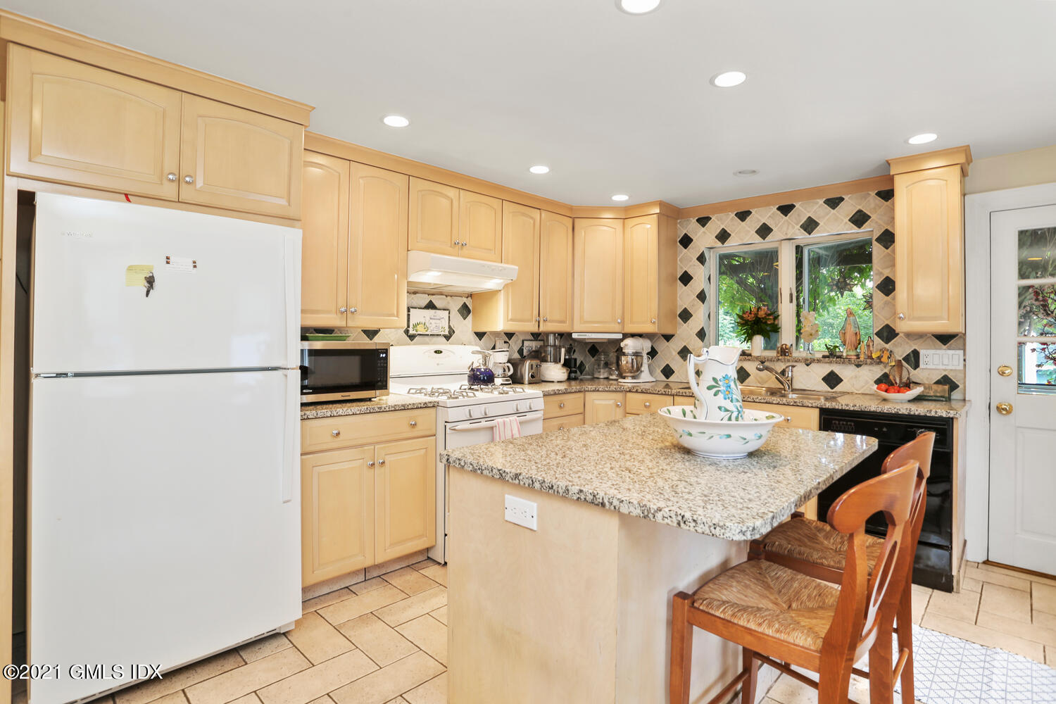 45 Rodwell Avenue Greenwich, CT 06830 - Photo 14 of 42 a kitchen with refrigerator and cabinets