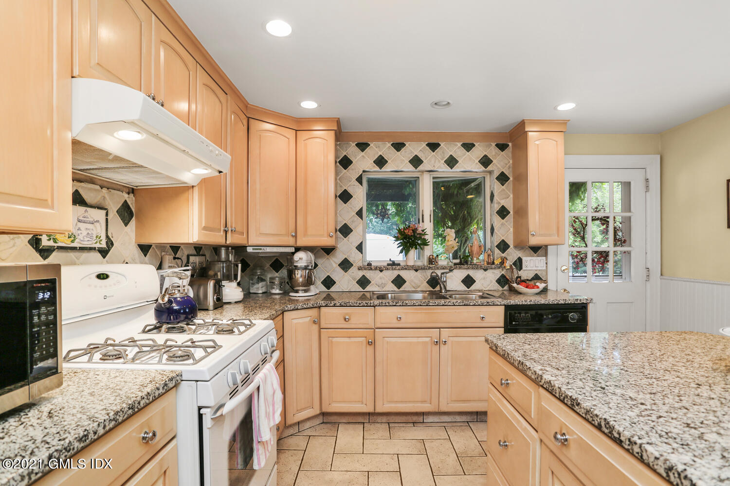 45 Rodwell Avenue Greenwich, CT 06830 - Photo 15 of 42 a kitchen with stainless steel appliances kitchen island granite countertop a sink and cabinets