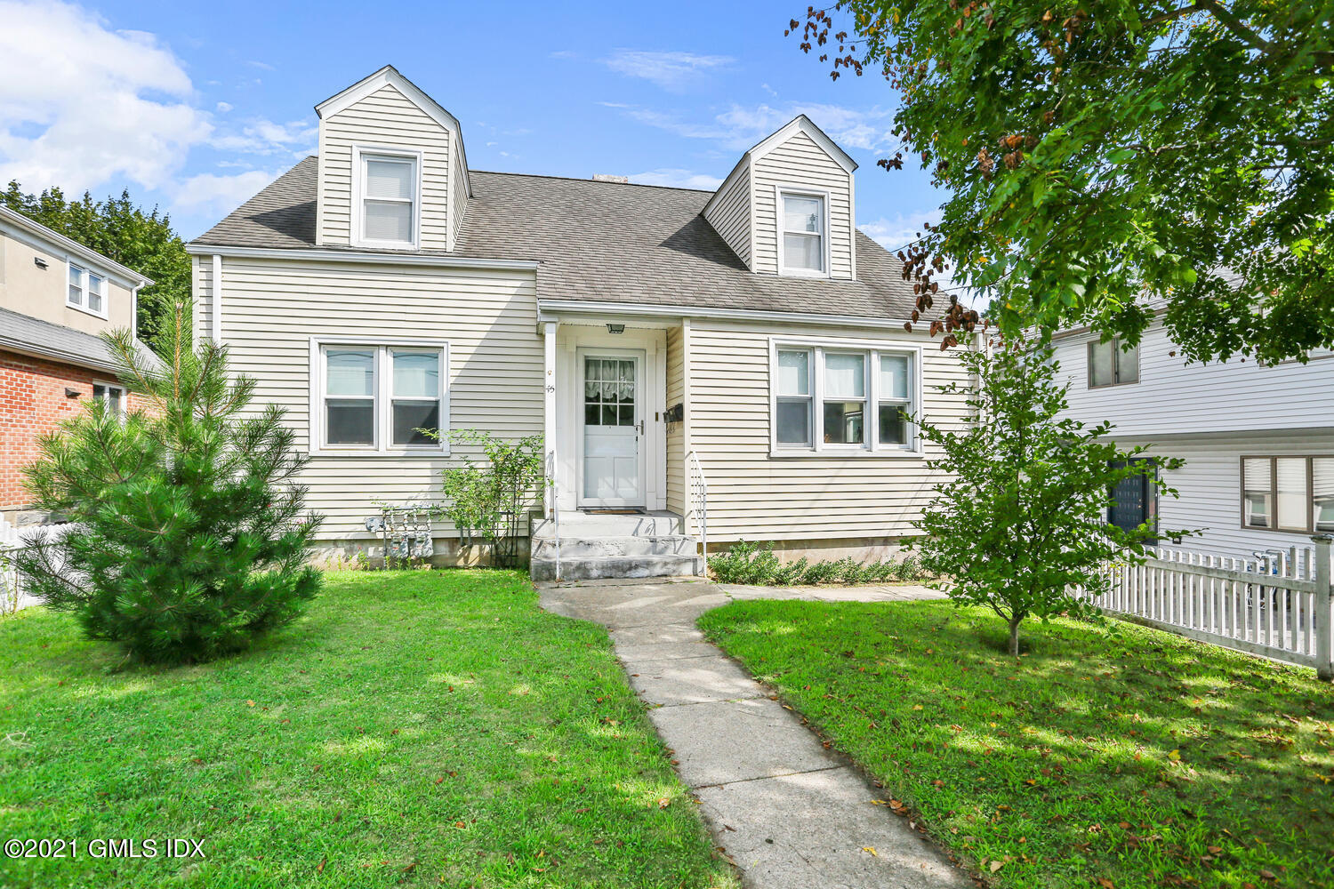 45 Rodwell Avenue Greenwich, CT 06830 - Photo 2 of 42 a front view of a house with a yard