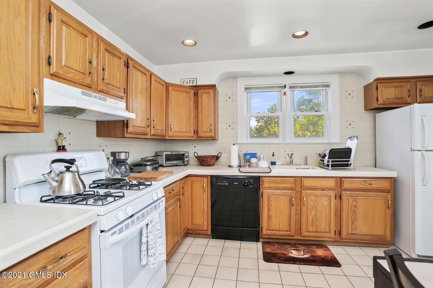 45 Rodwell Avenue Greenwich, CT 06830 - Photo 25 of 42 a kitchen with a sink stove and cabinets