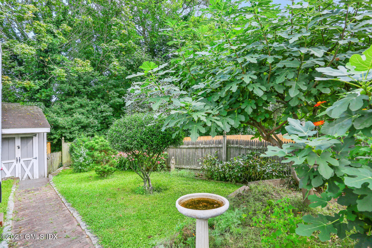 45 Rodwell Avenue Greenwich, CT 06830 - Photo 37 of 42 a view of a backyard with table and chairs plants