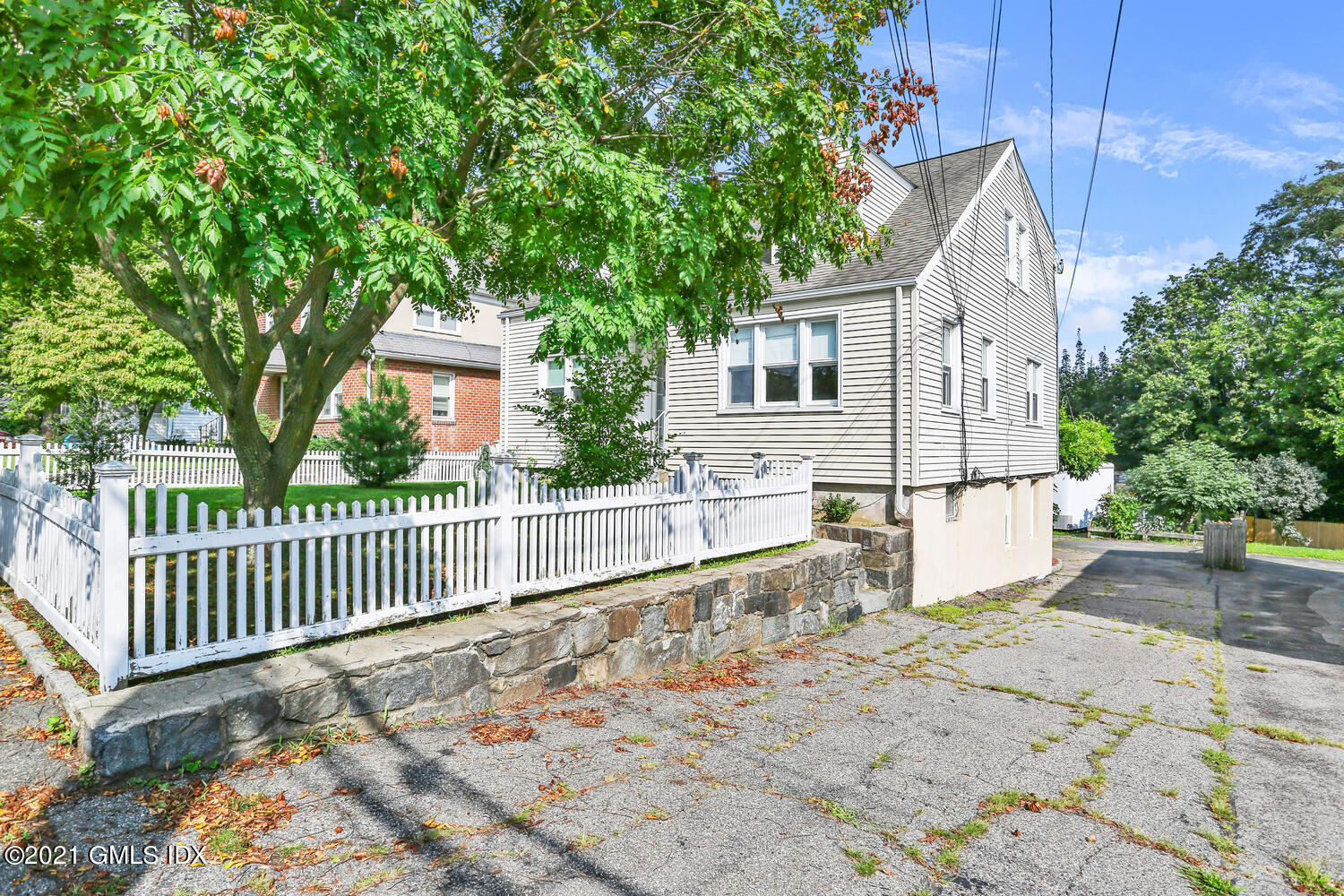 45 Rodwell Avenue Greenwich, CT 06830 - Photo 5 of 42 a view of a house with a small yard and wooden fence