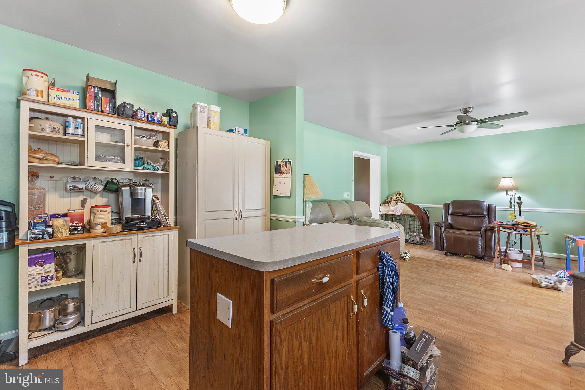 7112 East New Market Ellwood Road Hurlock, MD 21643 - Photo 12 of 41 a kitchen with stainless steel appliances granite countertop a table chairs and a refrigerator