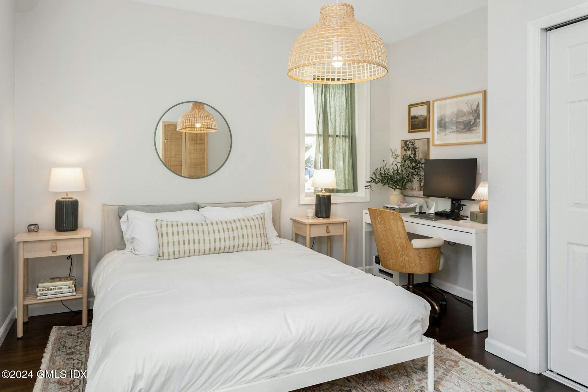 25 Bible Street, Unit 2 Cos Cob, CT 06807 - Photo 11 of 24 a bedroom with a bed and a chandelier