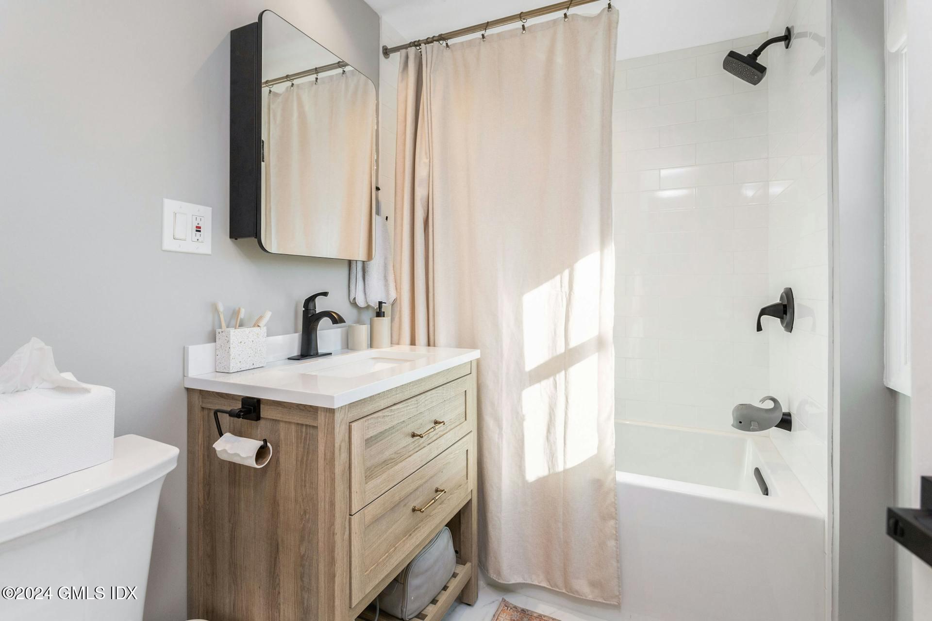 25 Bible Street, Unit 2 Cos Cob, CT 06807 - Photo 18 of 24 a bathroom with a sink a toilet and shower