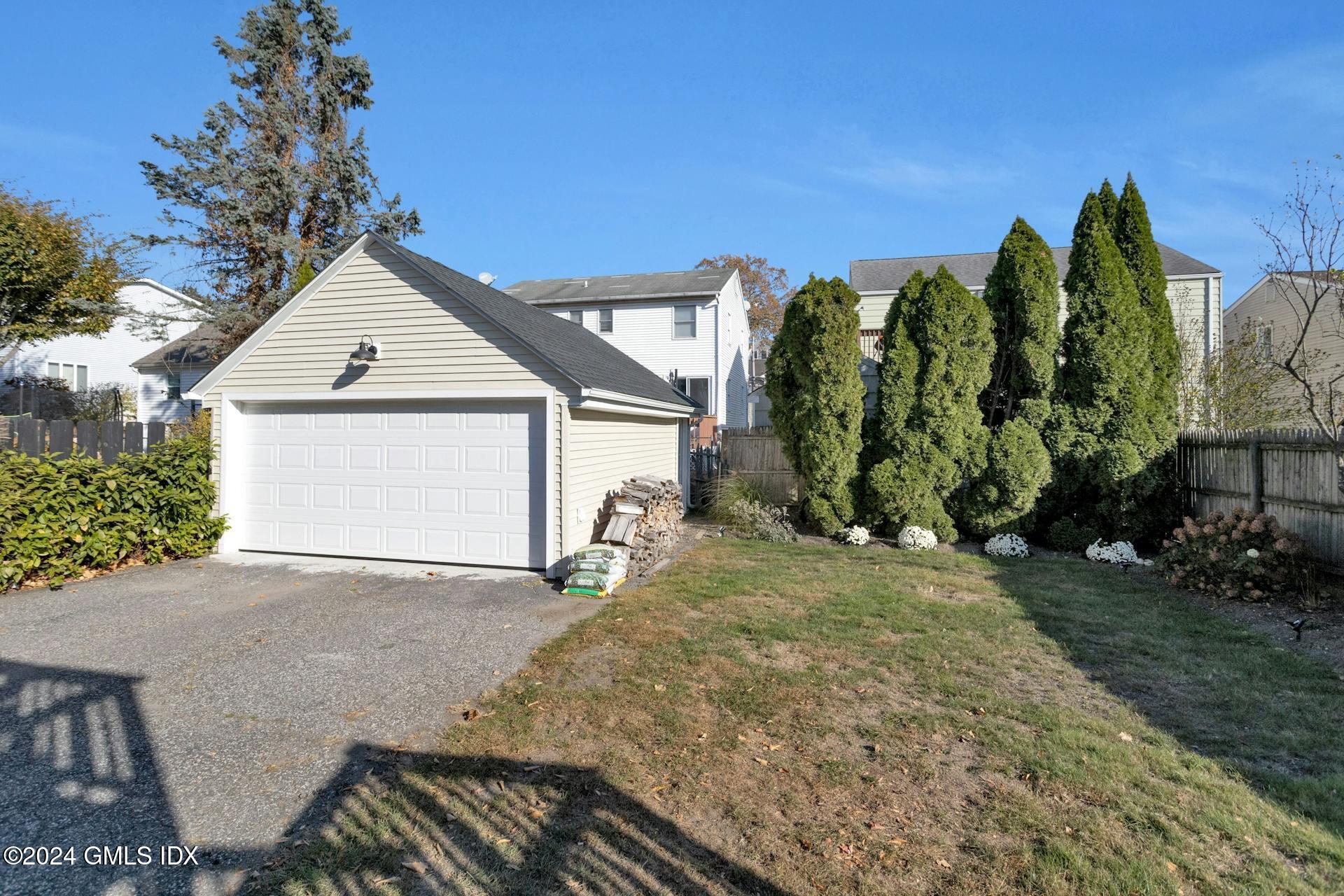 25 Bible Street, Unit 2 Cos Cob, CT 06807 - Photo 21 of 24 a view of a house with a yard and potted plants
