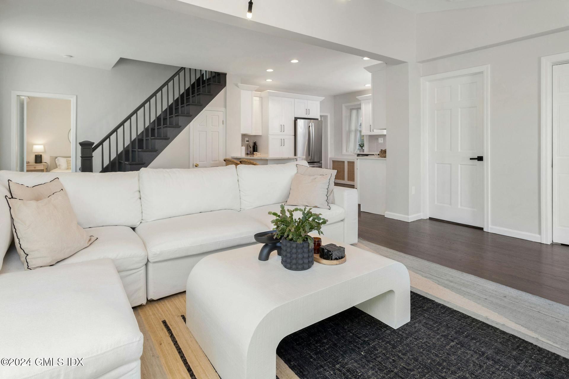 25 Bible Street, Unit 2 Cos Cob, CT 06807 - Photo 3 of 24 a living room with furniture potted plant and white walls