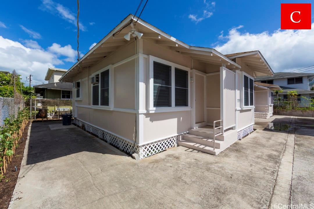 a front view of a house with a yard outdoor seating and garage