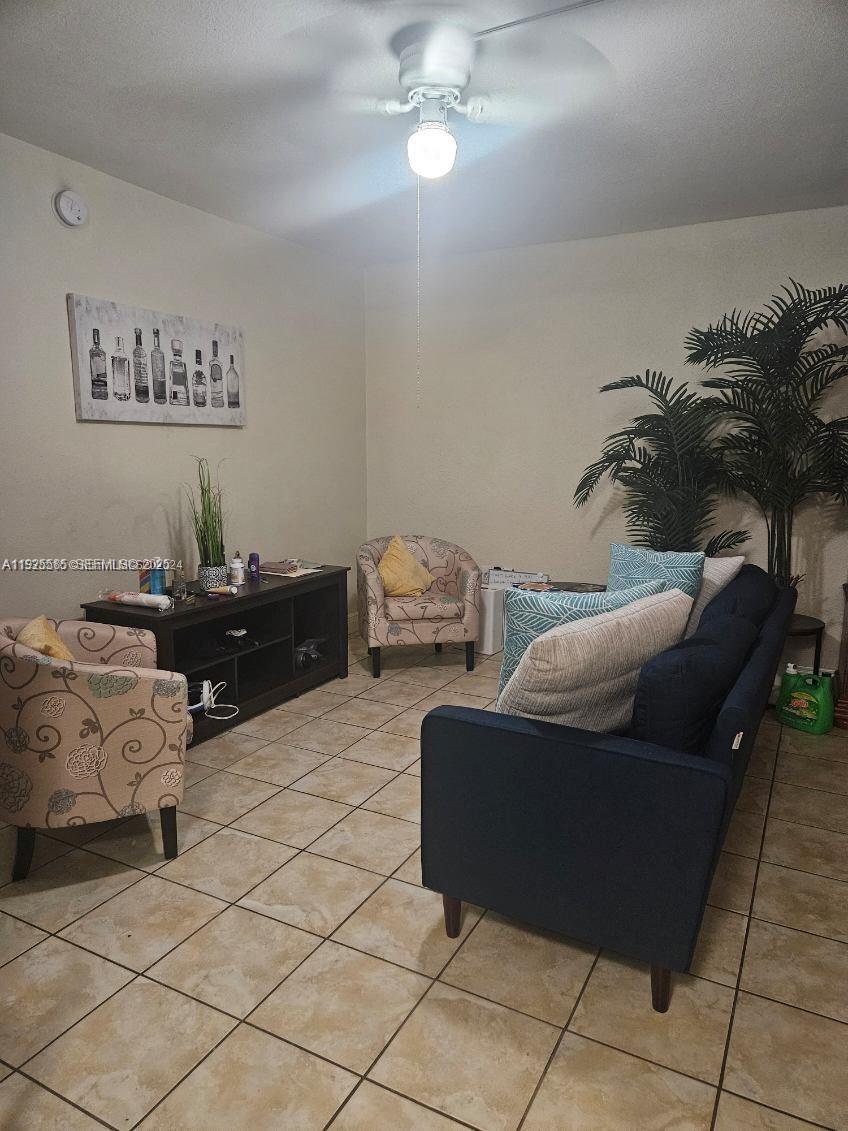 3071 Southwest 27th Avenue, Unit 9 Miami, FL 33133 - Photo 1 of 1 a living room with furniture and a lamp