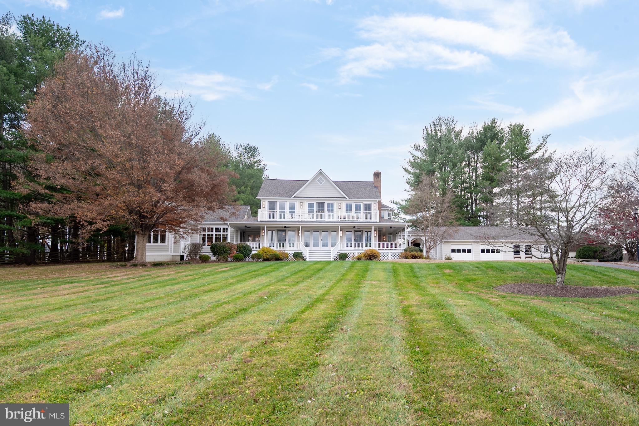 37896 Legard Farm Road Purcellville, VA 20132 - Photo 2 of 117 a view of a house with a big yard and large trees