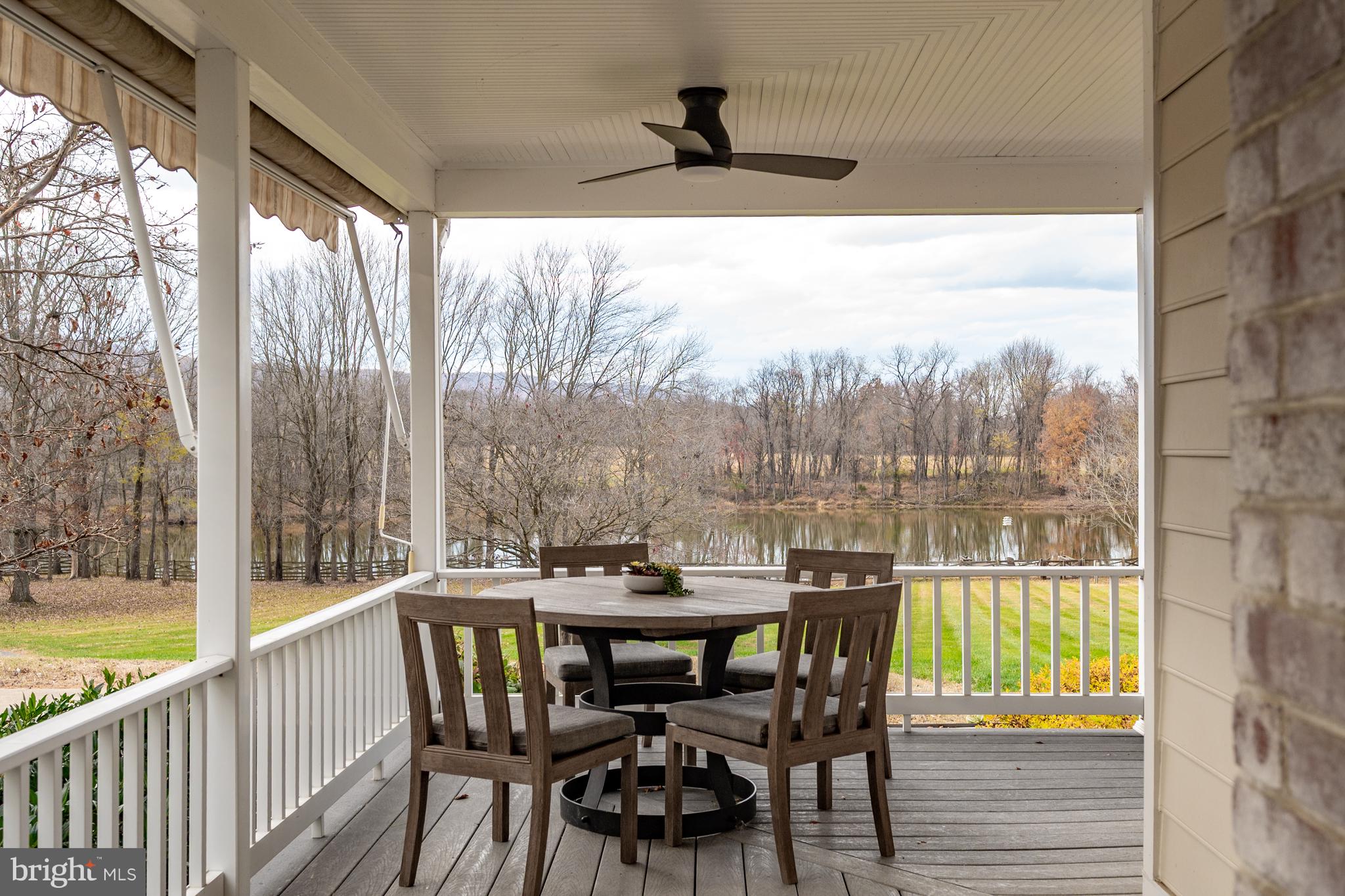 37896 Legard Farm Road Purcellville, VA 20132 - Photo 35 of 117 a view of a patio with a table chairs and wooden floor