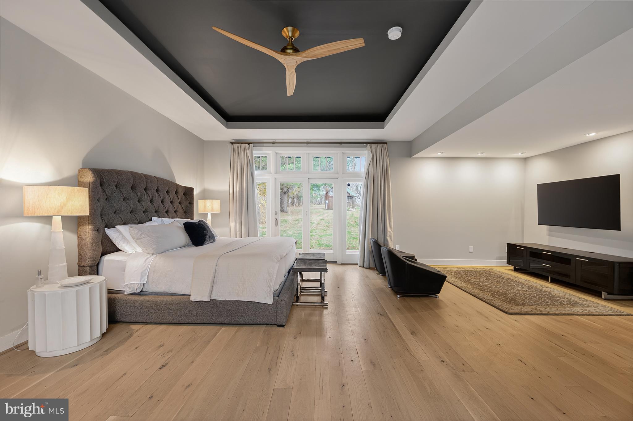 37896 Legard Farm Road Purcellville, VA 20132 - Photo 38 of 117 a spacious bedroom with a bed and a flat screen tv