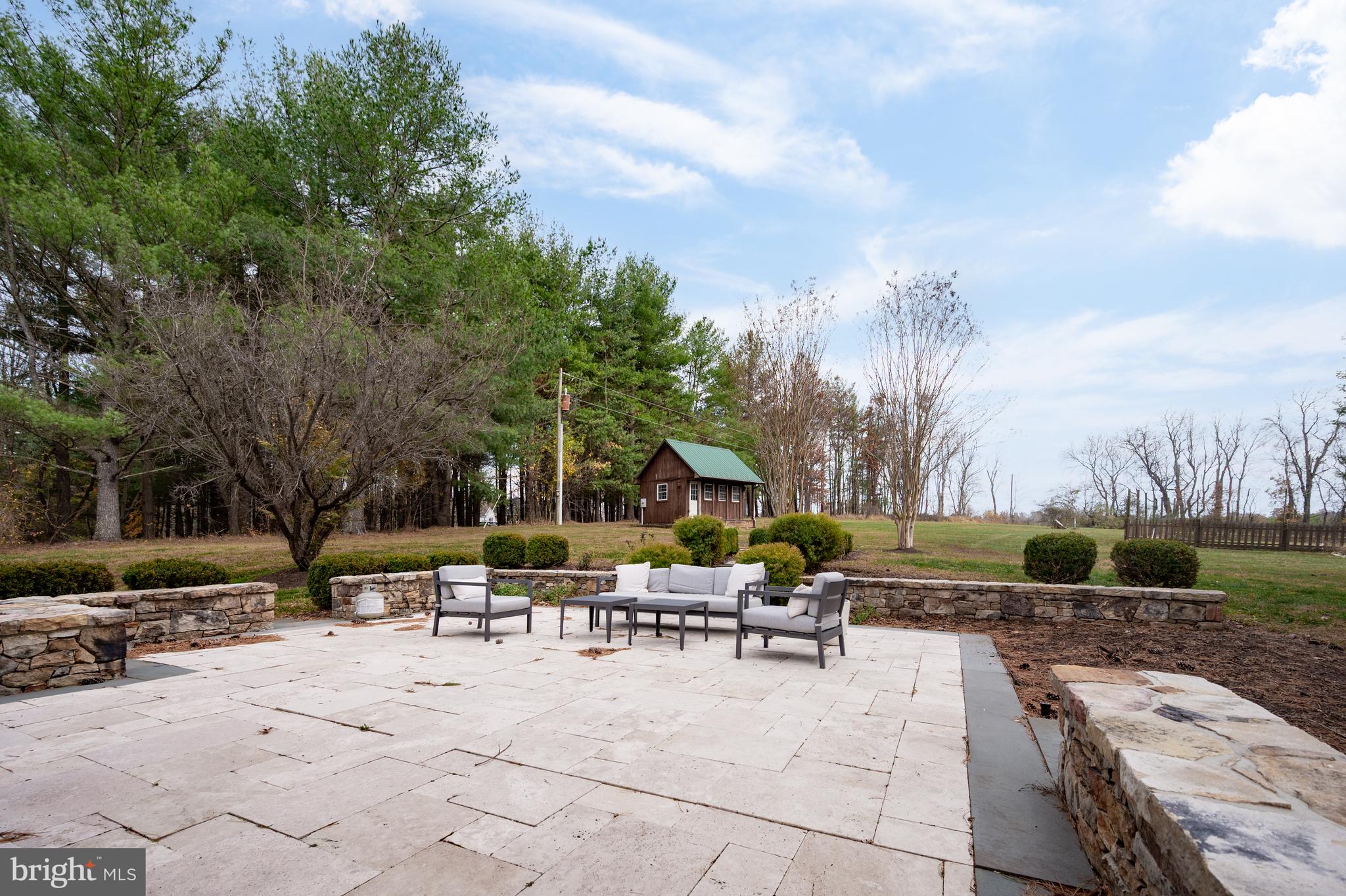 37896 Legard Farm Road Purcellville, VA 20132 - Photo 54 of 117 a view of a patio with chairs and a fire pit