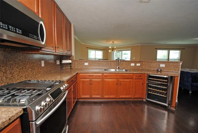 a kitchen with stainless steel appliances granite countertop a stove and a sink