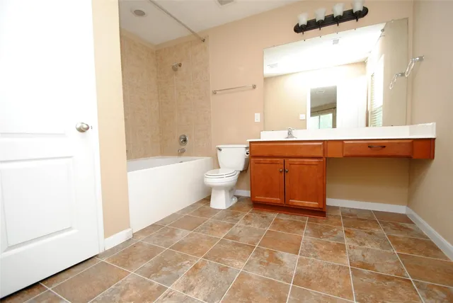 a bathroom with a toilet a sink and bathtub
