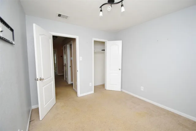an empty room with a ceiling fan