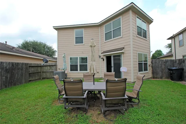 a view of a backyard with a table and chairs