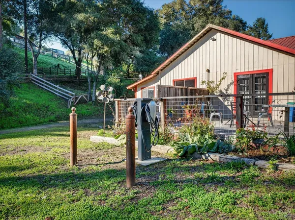 a view of a house with a yard and sitting area