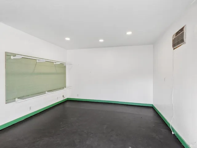 a view of a house that has a small yard and a large tree