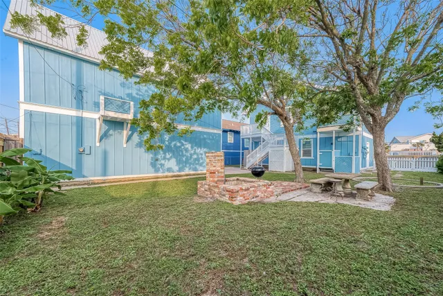 a view of a patio with table and chairs with wooden floor and fence