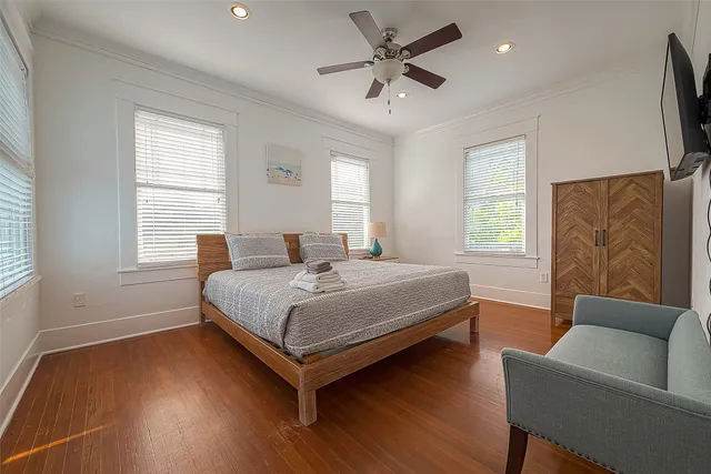 a living room with furniture and a wooden floor