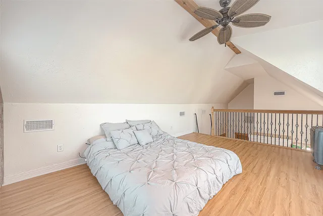 an empty room with a window and a ceiling fan