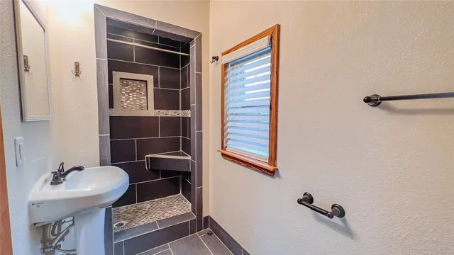 a picture of a bathroom with a shower