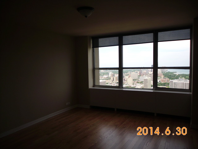 655 West Irving Park Road, Unit 4910 Chicago, IL 60613 - Photo 14 of 22 a view of an empty room with a window