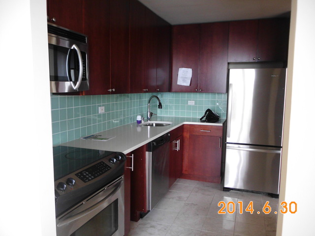 655 West Irving Park Road, Unit 4910 Chicago, IL 60613 - Photo 7 of 22 a kitchen with a refrigerator and a sink