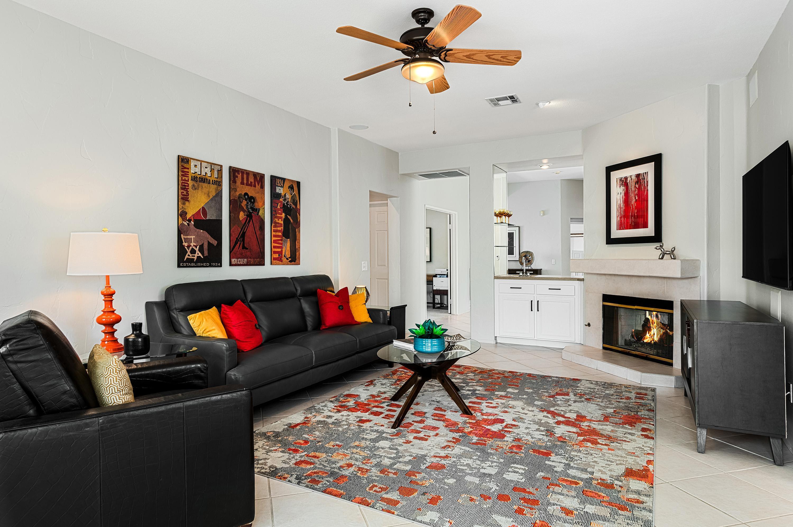 7 Florentina Drive Rancho Mirage, CA 92270 - Photo 11 of 45 a living room with furniture a fireplace and a flat screen tv