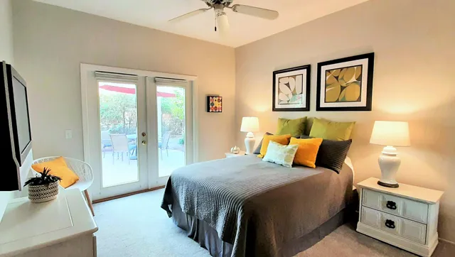 a bedroom with a bed and a desk