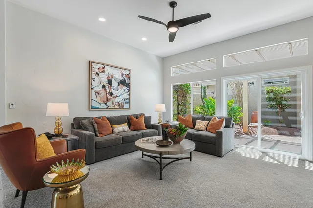 a spacious bedroom with a large bed and a flat tv screen on dresser