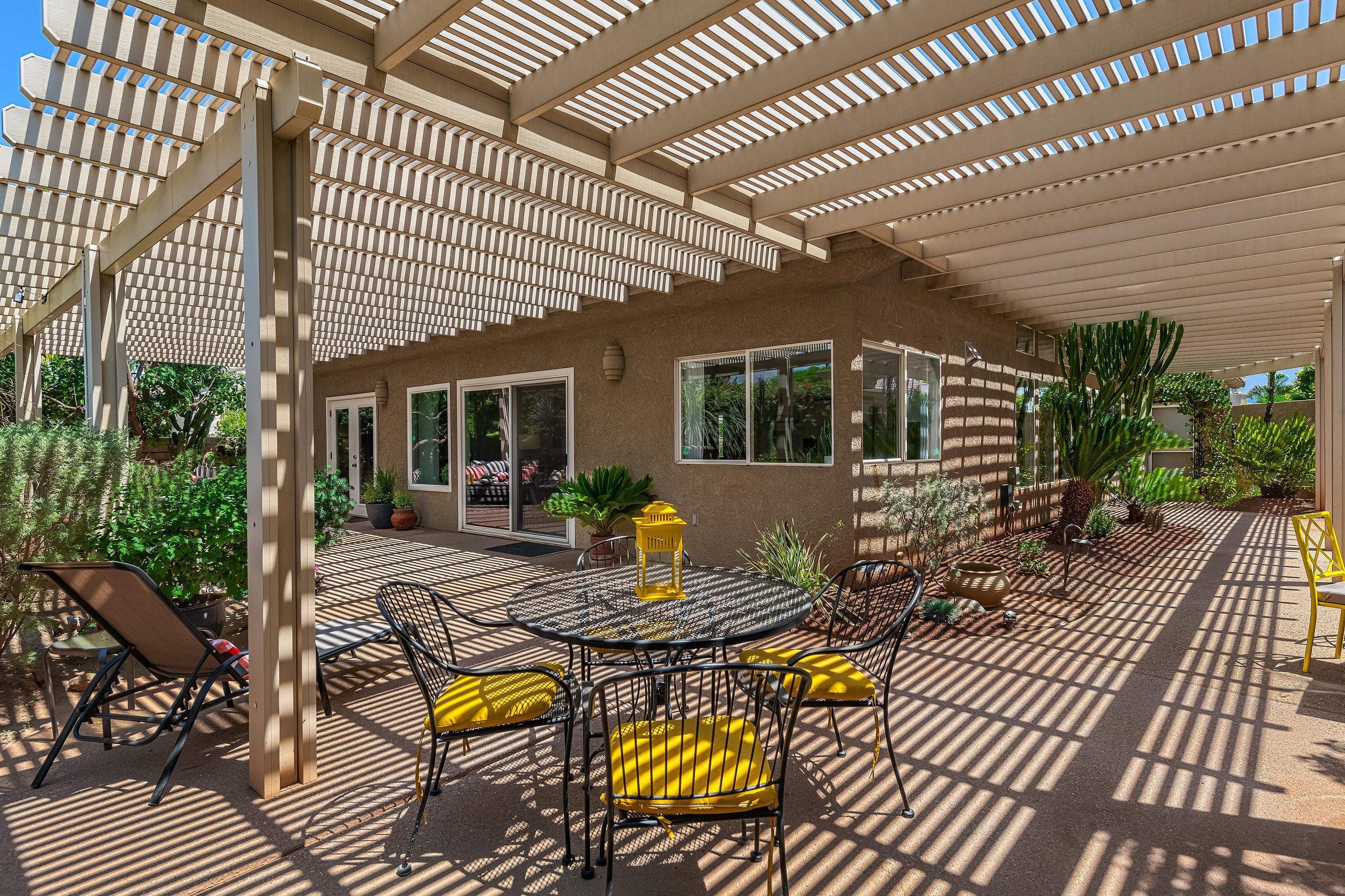 7 Florentina Drive Rancho Mirage, CA 92270 - Photo 31 of 45 a view of a patio with table and chairs and wooden floor