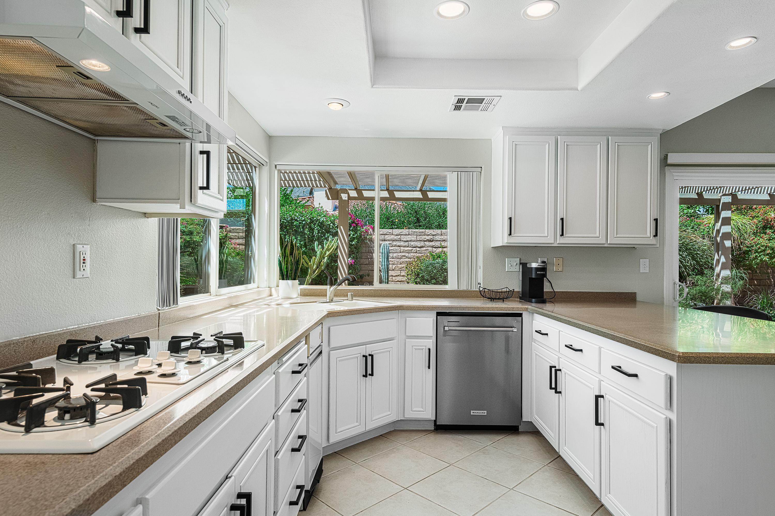 7 Florentina Drive Rancho Mirage, CA 92270 - Photo 7 of 45 a kitchen with a sink stove and cabinets
