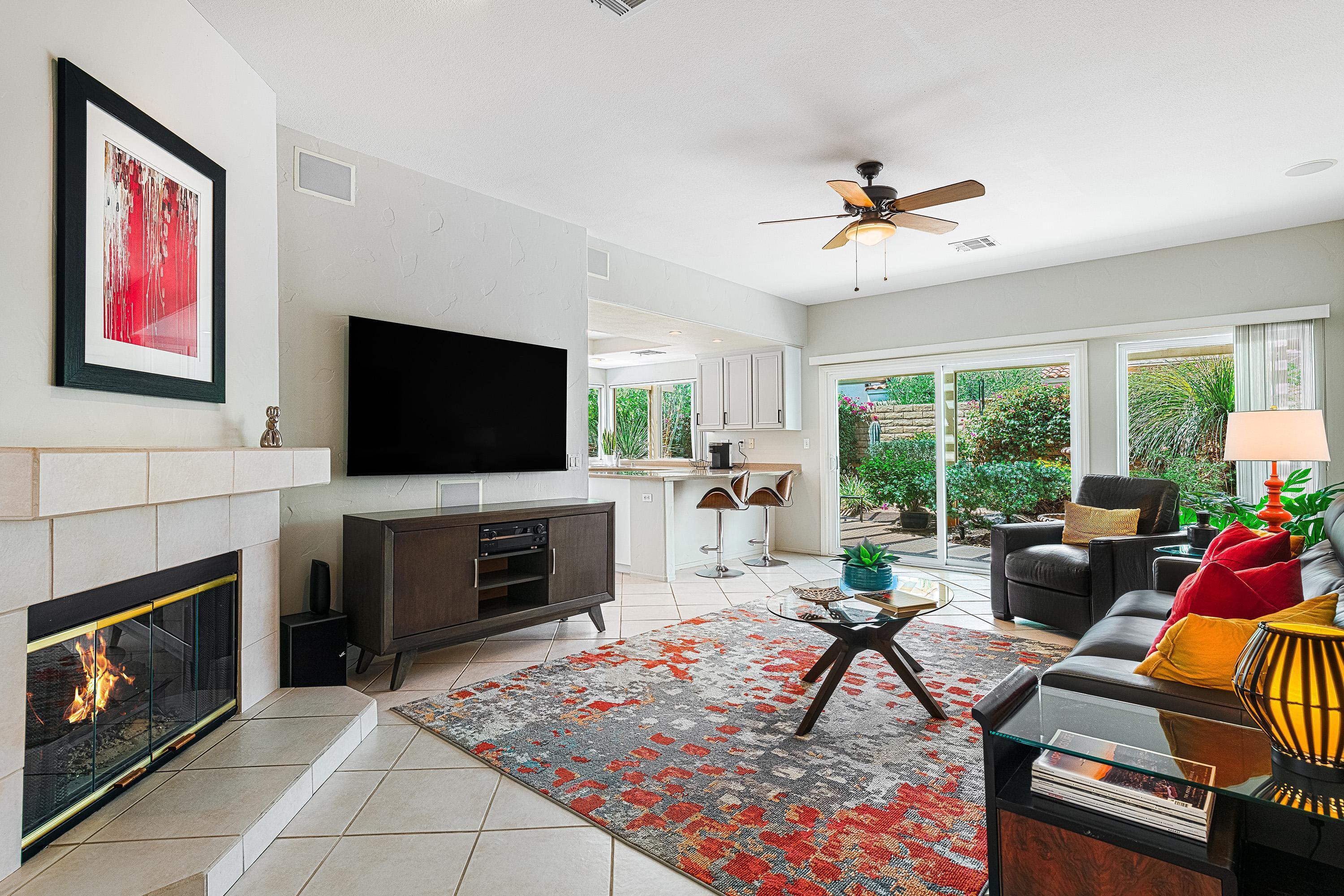 7 Florentina Drive Rancho Mirage, CA 92270 - Photo 10 of 45 a living room with furniture a flat screen tv and a fireplace