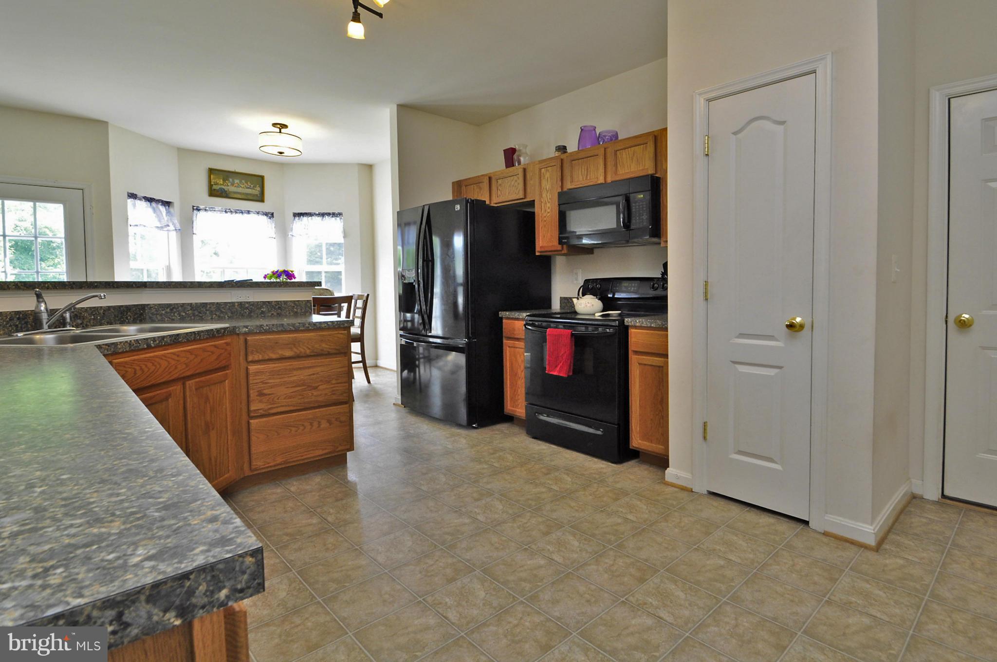 4625 Lewiston Road Bumpass, VA 23024 - Photo 18 of 30 a kitchen with stainless steel appliances granite countertop a refrigerator and a sink