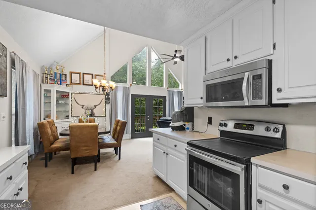 a kitchen with a stove a sink and a microwave