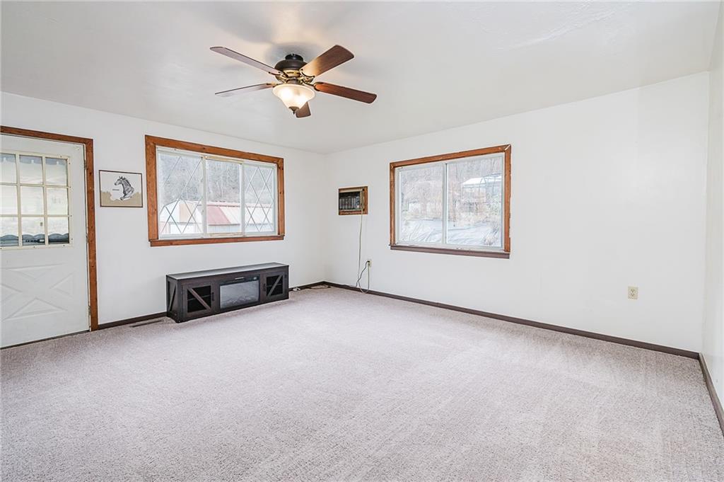 28 Indiana Avenue Avonmore, PA 15618 - Photo 14 of 49 an empty room with windows and ceiling fan